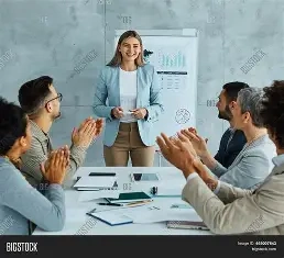 A group of professionals in an office setting clapping for a SMM expert standing in front of a whiteboard with charts. Best Freelance Digital Marketing Analyst in calicut